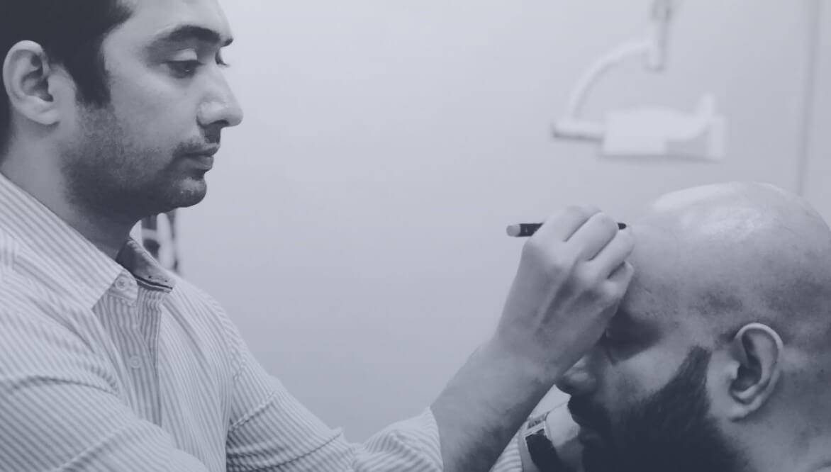 Dr Malay Mehta discussing a hairline with a patient